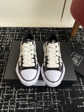 Black and white low-top sneakers with white laces and textured side panels