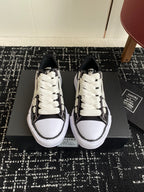 Black and white low-top sneakers with white laces and textured side panels