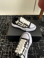 Black and white low-top sneakers with white laces, split-toned midsole