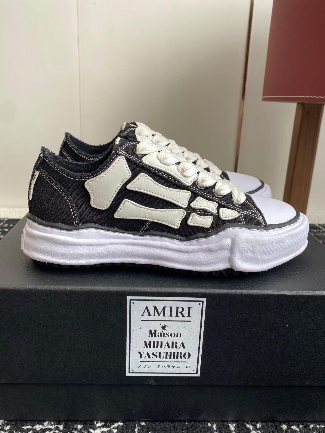 Black and white low-top sneakers with white laces and contrast side stripe