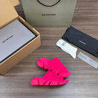 Bright pink Balenciaga slide sandals, angled view with three front straps