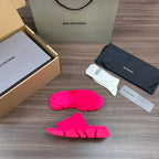 Bright pink Balenciaga slide sandals with three front straps and thick textured sole