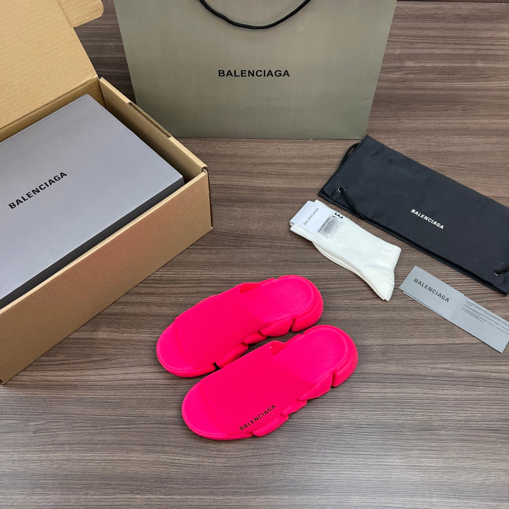 Bright pink Balenciaga slide sandals with cushioned footbed and thick outsole