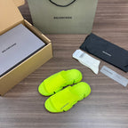 Balenciaga neon green sandals, angled view, chunky platform slides