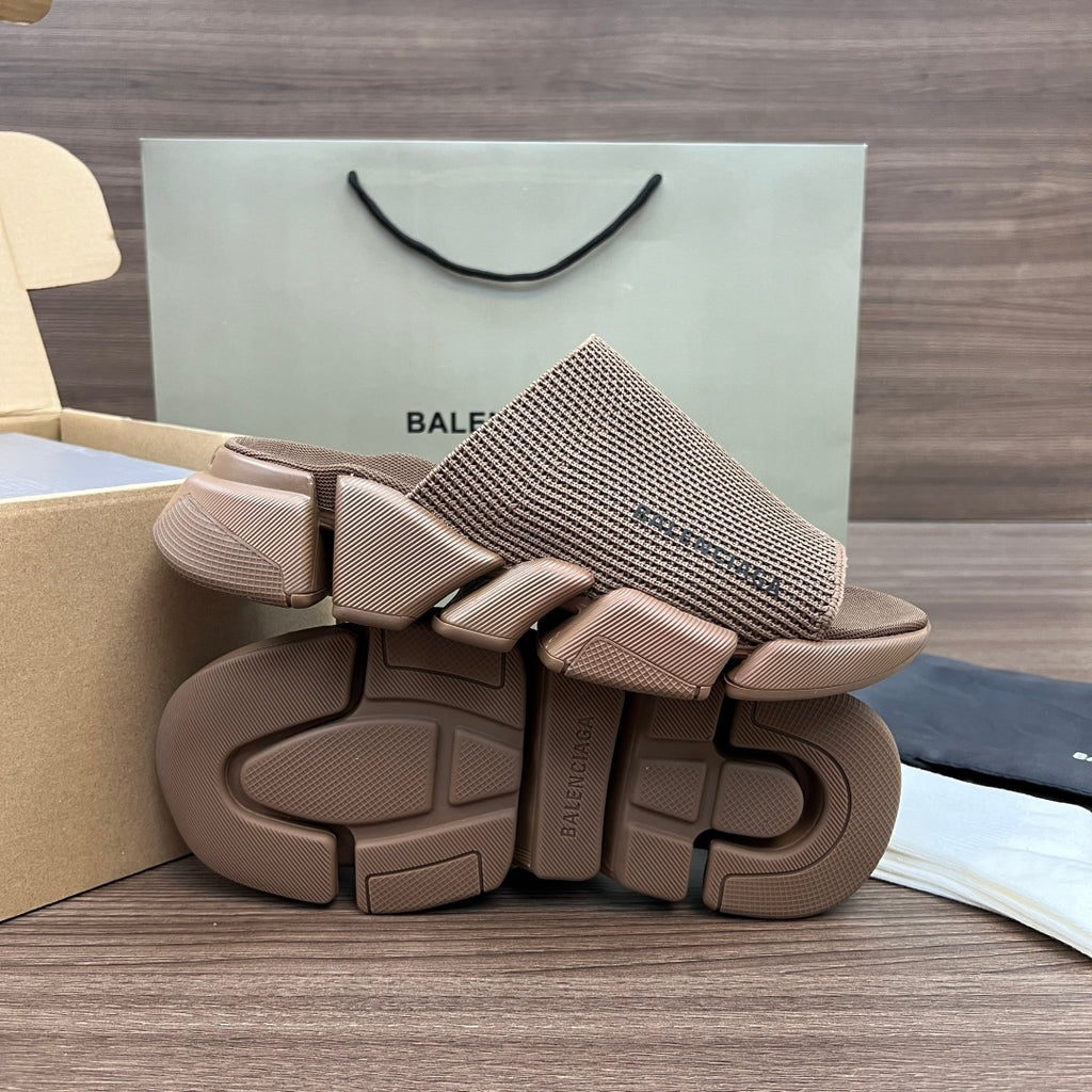 Tan knit slide sandals with thick treaded rubber sole and strap details