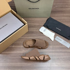 Tan knit slide sandals with buckle strap detail and chunky rubber sole