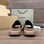 Tan knit slide sandals with rear logo heel panel and chunky rubber sole