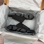 Balenciaga dark rubber slide sandals with wide strap and textured upper