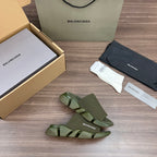 Green knit slide sandals, angled view with open toe and layered sole
