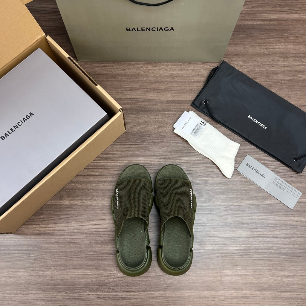 Green knit slide sandals with wide straps and textured footbed