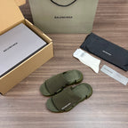 Green knit slide sandals, side view showing adjustable-style strap details