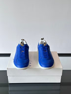 Blue lace-up sneakers with white soles, back view showing heels on a box