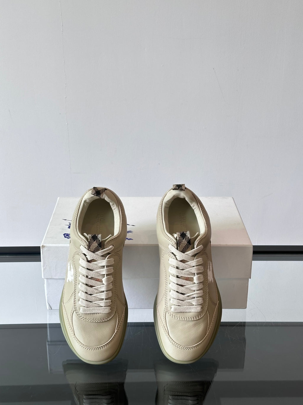 Burberry cream low-top sneakers, back view with lace-up and heel pull tabs