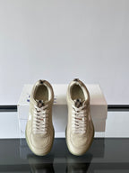 Burberry cream low-top sneakers, back view with lace-up and heel pull tabs