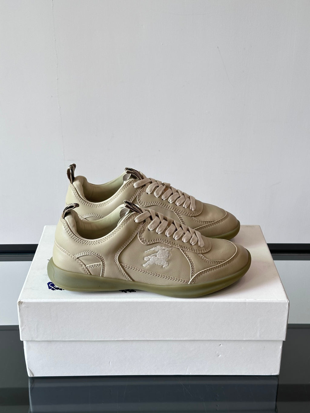 Burberry low-top lace-up sneakers, cream leather uppers, rubber sole