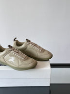 Burberry cream lace-up sneakers, two pairs side by side on box, logo at side