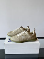 Burberry cream leather low-top sneakers, side view with logo patch and laces