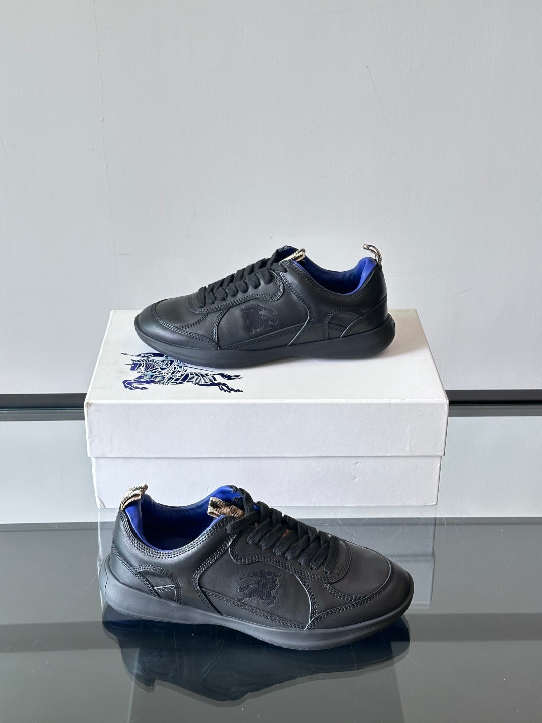 Burberry lace-up sneakers on box, dark finish with blue interior collar