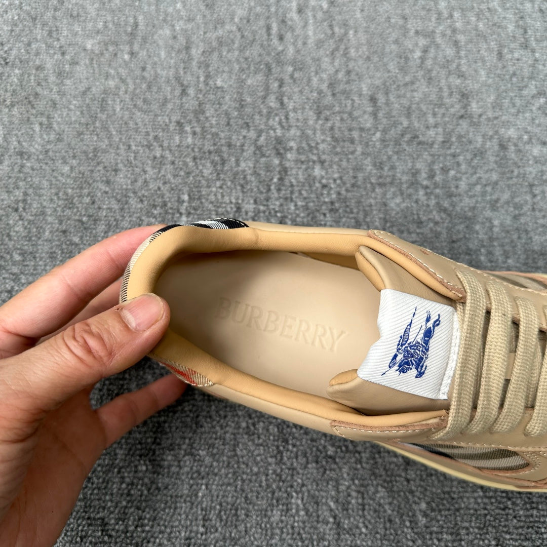 Beige sneaker interior view with brand print, blue logo label, and lace-up upper