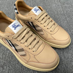 Close-up beige sneakers showing lace eyelets, plaid side panel, and embroidered polo logo