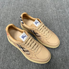 Beige leather sneakers with lace-up closure, plaid panel accents, cream rubber sole
