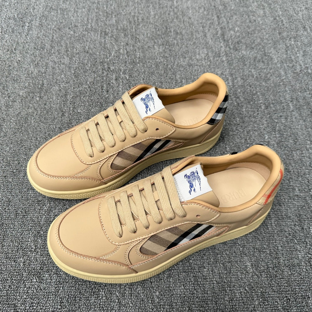 Pair of beige lace-up sneakers with blue-and-white plaid stripe inserts and textured sole