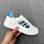 Burberry luxury white sneaker with blue-and-black check inset and bright blue collar lining