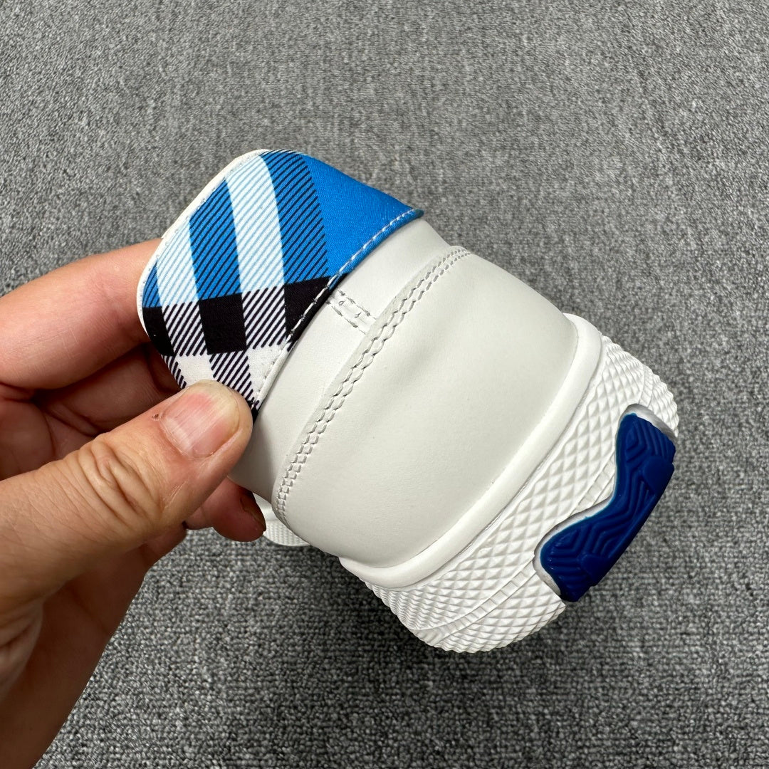 Burberry luxury white sneaker heel with blue-and-black check sock and textured tread