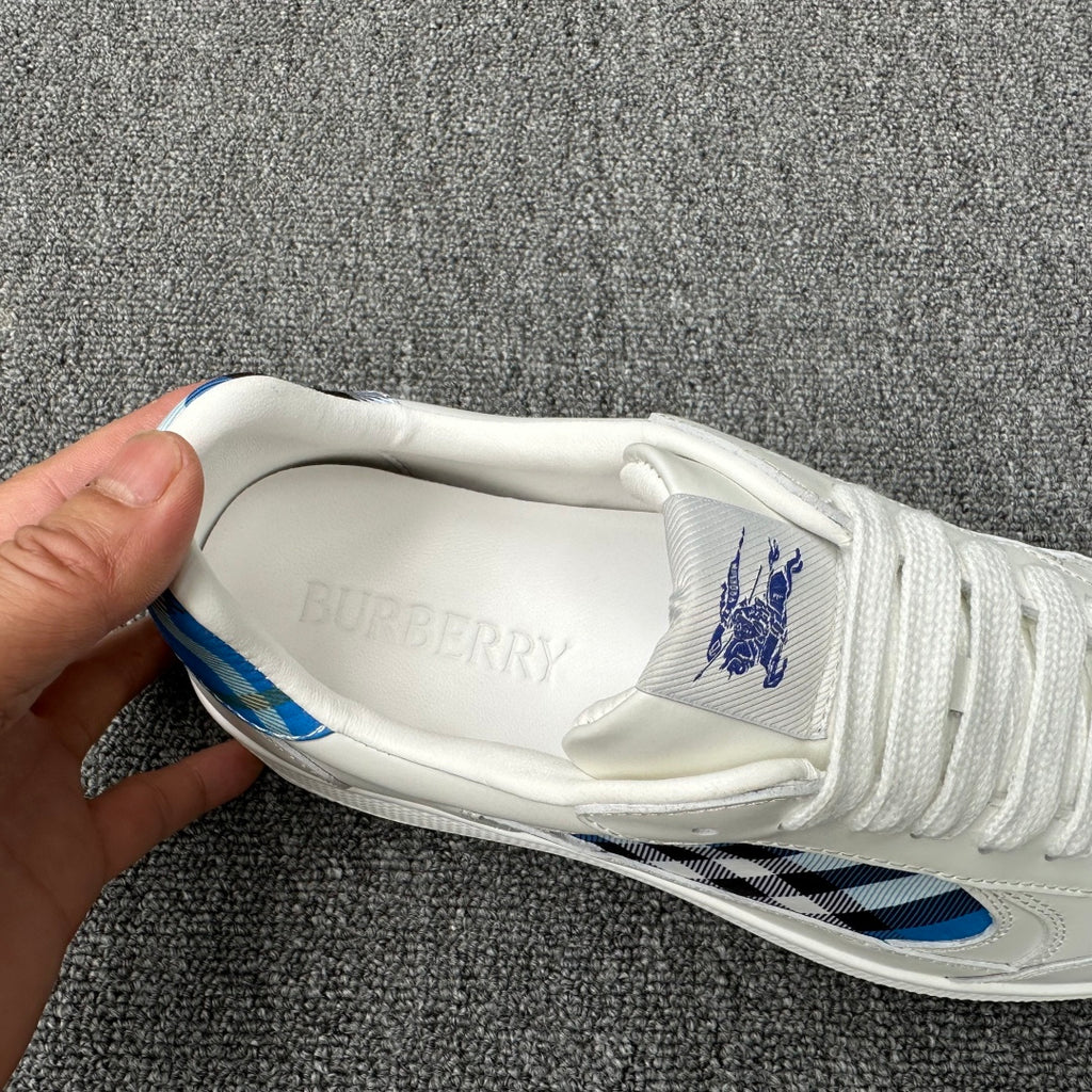 Burberry luxury white sneaker interior with embossed Burberry lettering on the tongue
