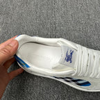 Burberry luxury white sneaker interior with embossed Burberry lettering on the tongue