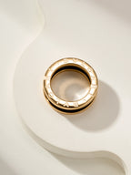 Gold-tone engraved band ring with open inner profile