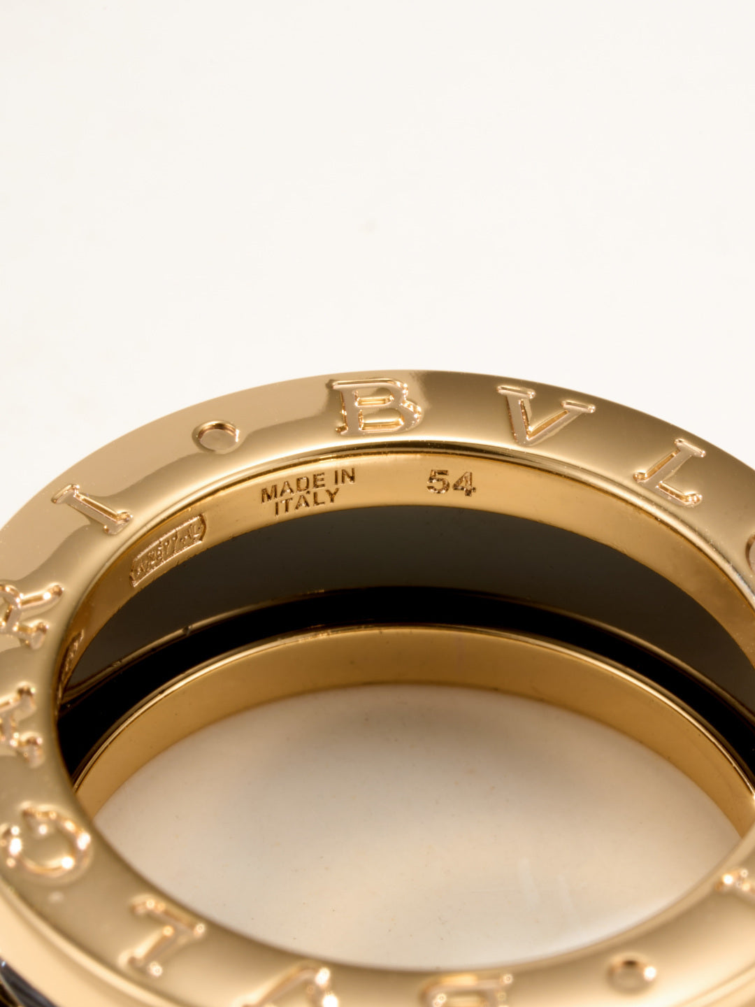 Close-up gold-tone ring showing 'MADE IN ITALY' text on inner band