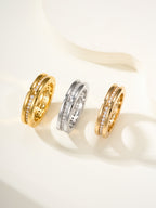 Set of three rings in gold and silver with sparkling stones along the bands