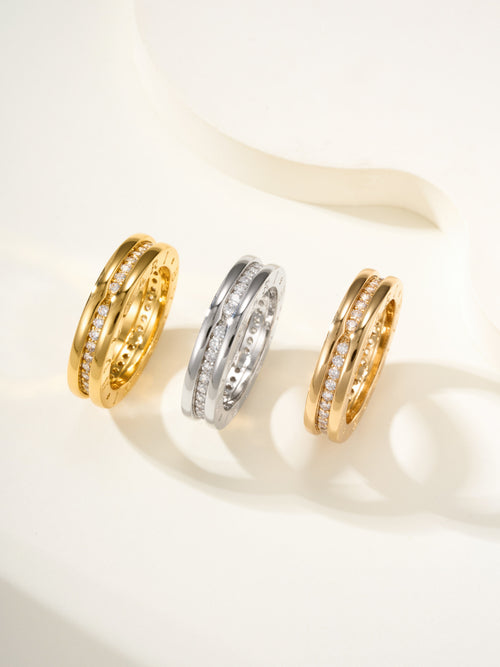 Set of three rings in gold and silver with sparkling stones along the bands
