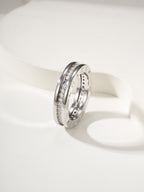 Silver-toned ring with sparkling stone inlays and engraved side details