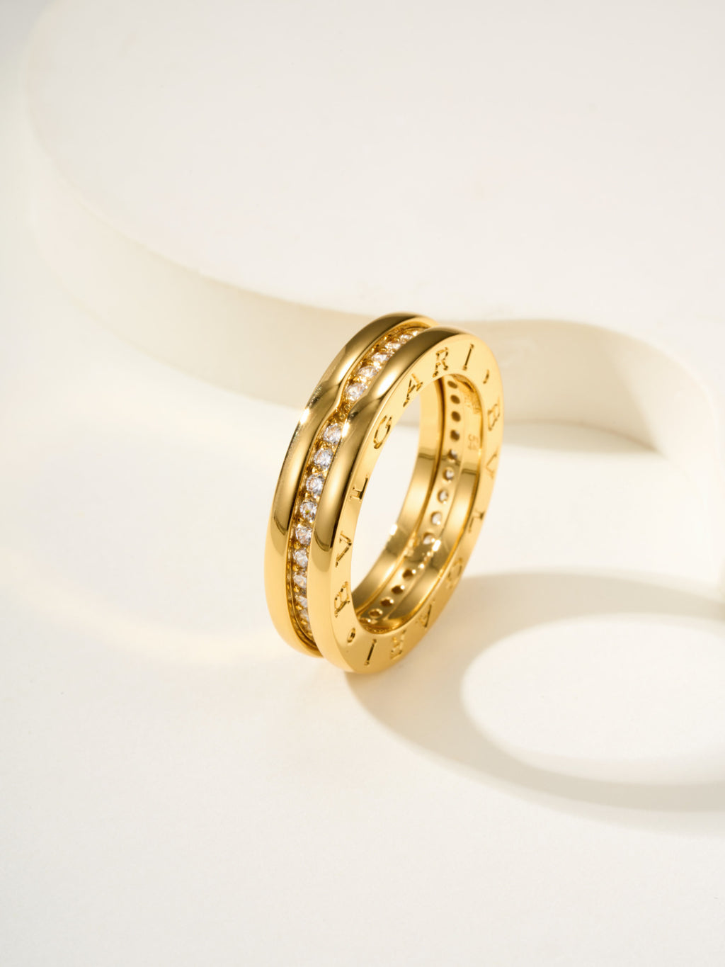 Gold multi-row ring with small gemstone details and engraved inner band
