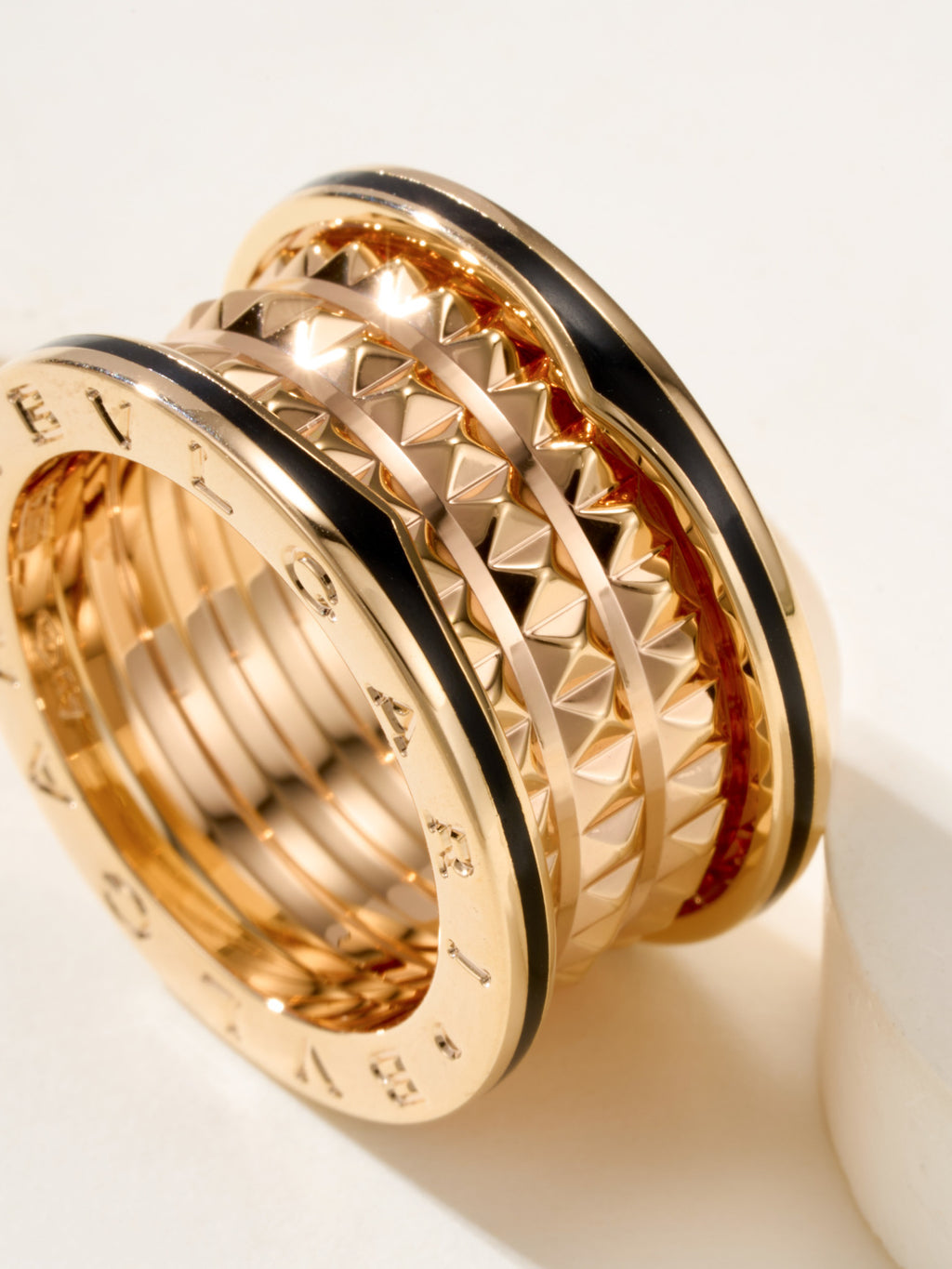 Bvlgari gold-tone ring close-up, diamond-cut textured outer band details