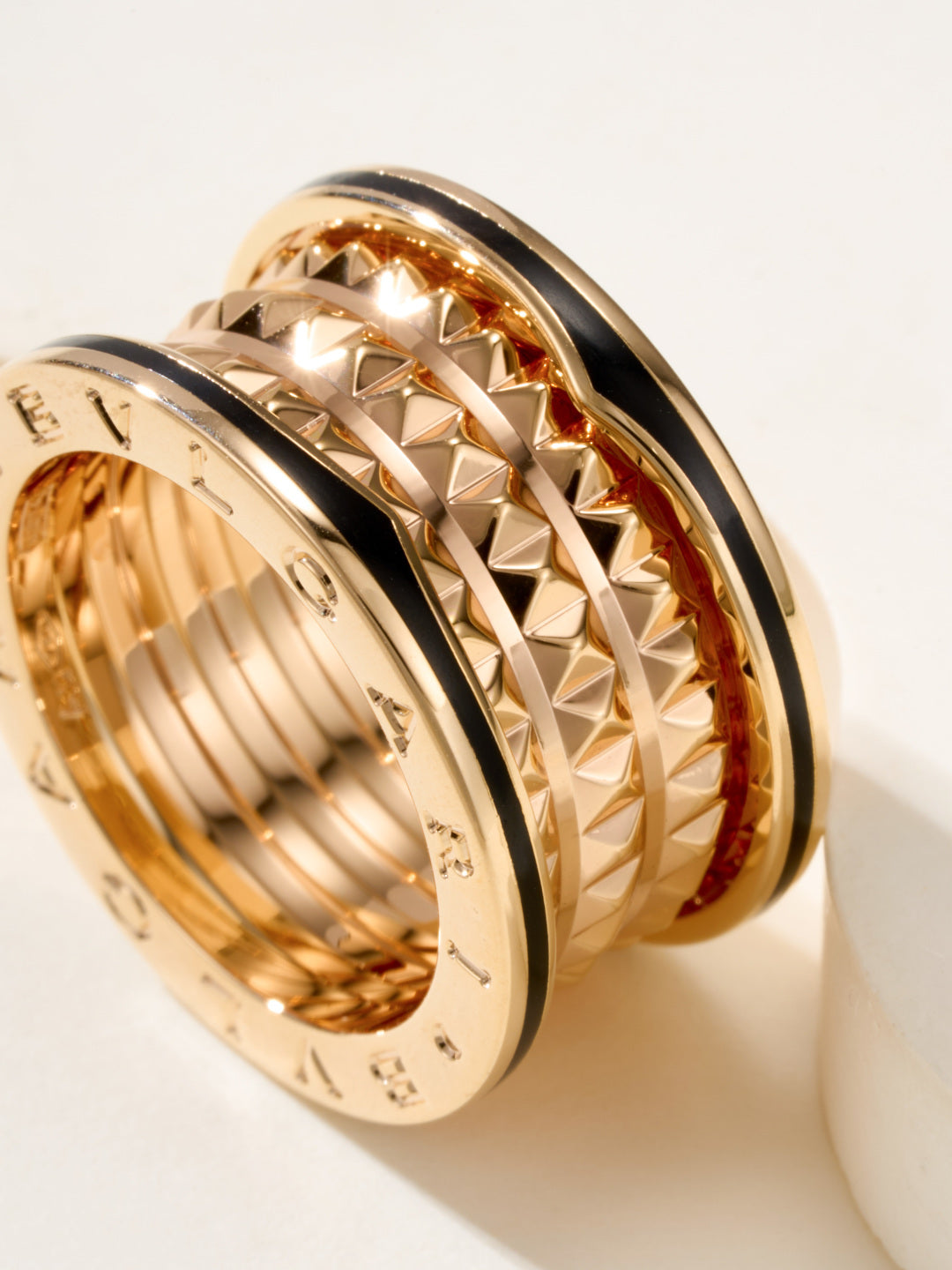 Bvlgari gold-tone ring close-up, diamond-cut textured outer band details
