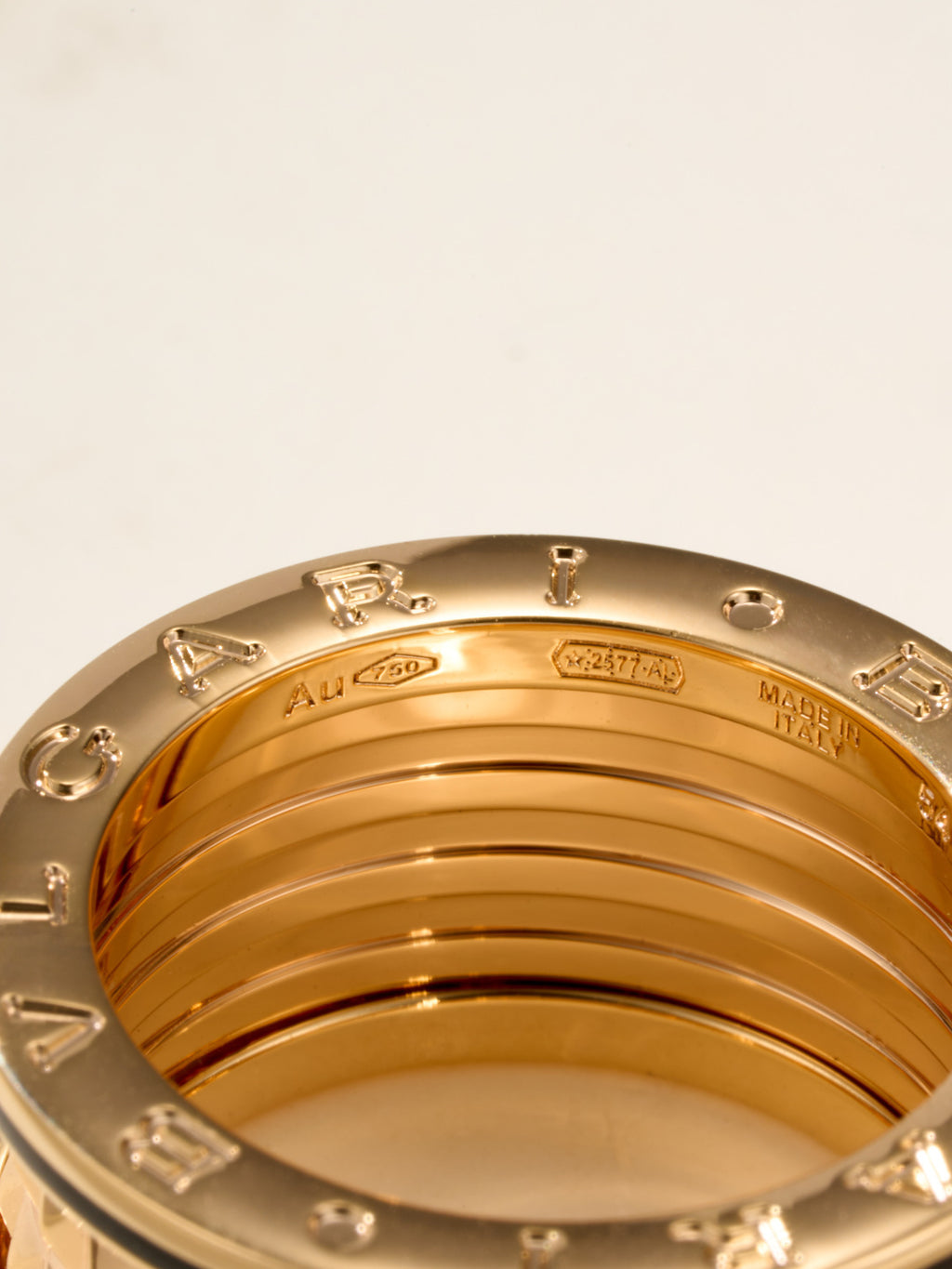 Bvlgari gold-tone ring inner band close-up with stamped icons and numbers
