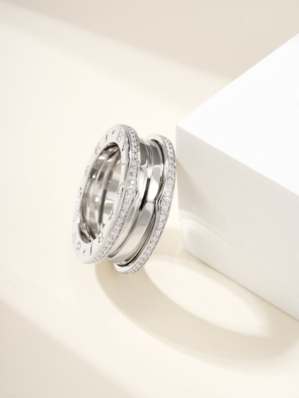 Silver ring with diamond pavé edge detailing and engraved outer band lettering