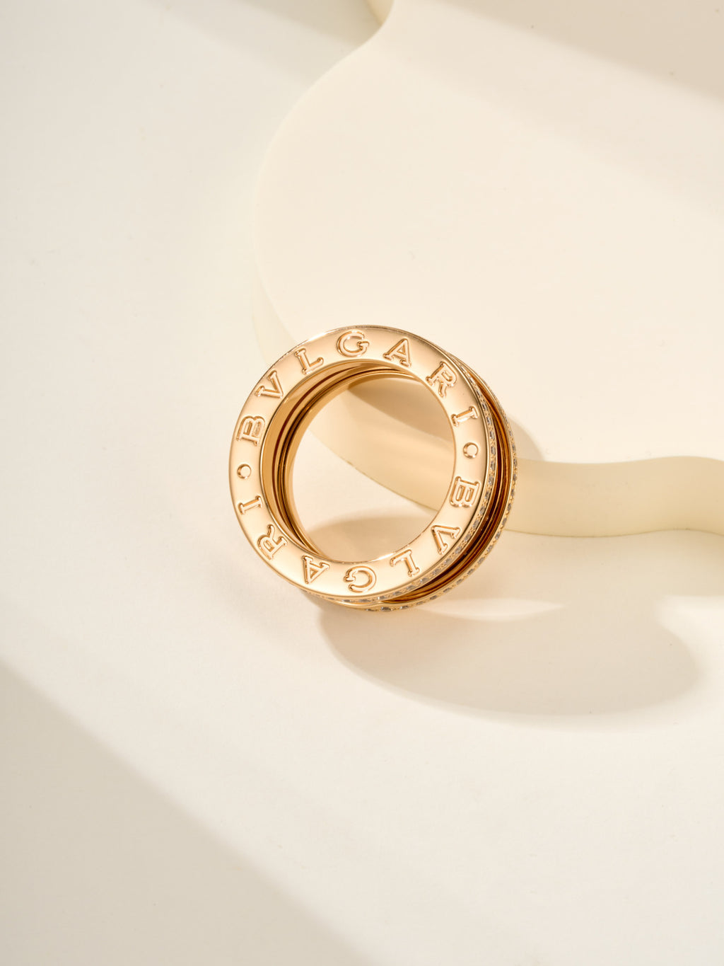 Gold ring with engraved outer band lettering and polished inner surface