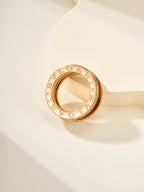 Gold ring with engraved outer band lettering and polished inner surface
