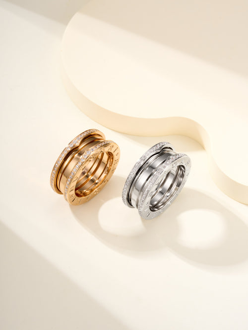 Stacked ring set with gold and silver bands, each with diamond pavé detailing