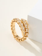 Bvlgari diamond ring, gold-tone linked band with square-cut stones, shown on pedestal