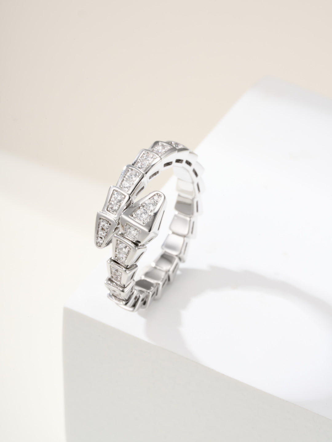 Bvlgari diamond ring, silver-tone linked band with square-cut stones on pedestal
