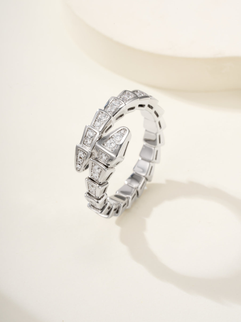 Bvlgari diamond ring, silver-tone linked band with square-cut stones, angled view