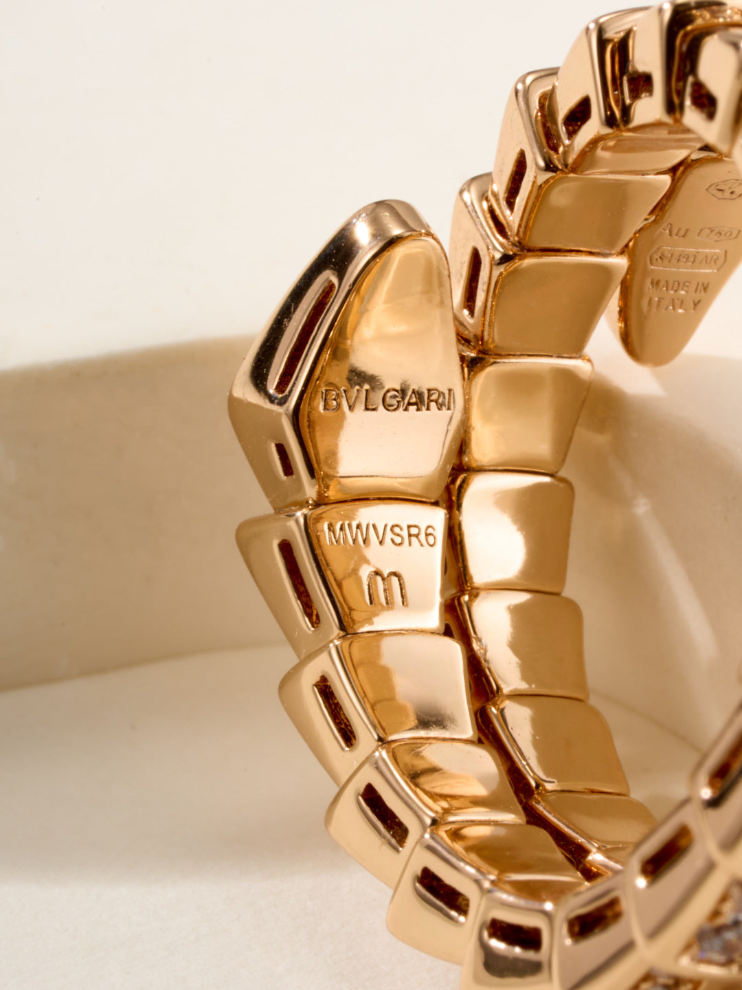 Bvlgari gold-tone ring close-up with engraved interior branding and markings