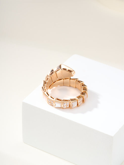 Rose gold-tone hinged bracelet with bezel-set square crystals across link segments