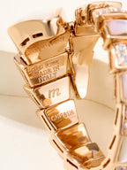 Rose gold bracelet clasp close-up with engraved marks and pavé square crystal stones