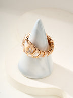 Rose gold-tone bracelet with square crystal center and angular open cuff on cone stand